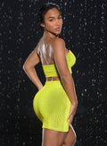 back right side profile view of a model in indoors looking over her shoulder wearing the Neon Nights Bikini Bandeau in Lemon Drop color