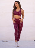 Front profile view of a model wearing our shine leopard leggings in Raspberry Leopard color along with a matching sports bra