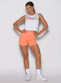Citrus Glow Lift Contour Shorts with a cross-over waistband and white Ombre Logo Tank gym set.