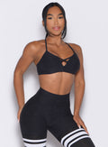 front profile view of a model wearing the Lift Luxe Sports bra in Heathered black color