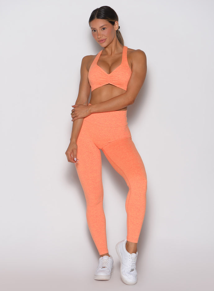 Front view of Citrus Glow Lift Movement Leggings and matching sports bra, a sculpting gym set.