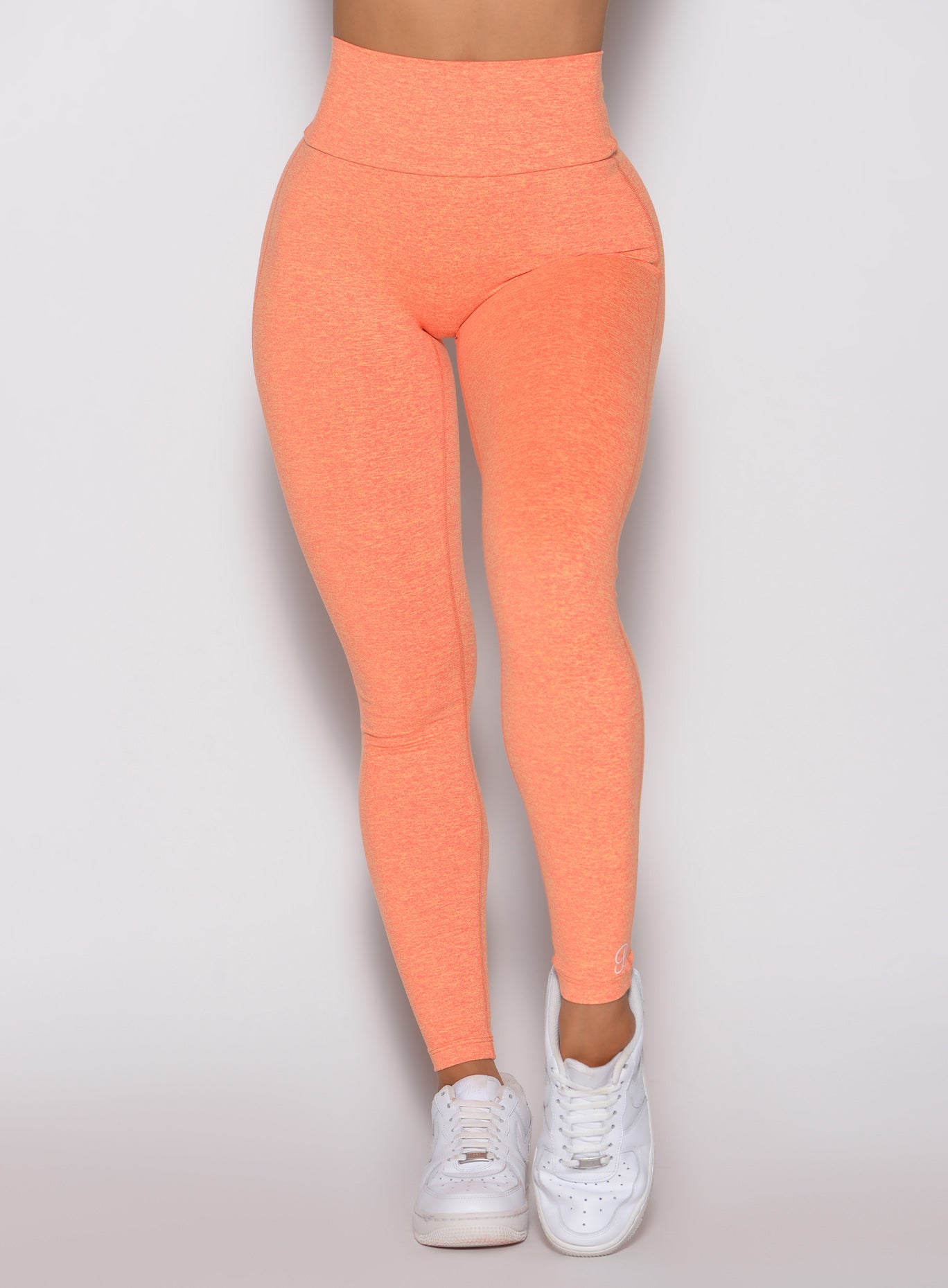 Close-up front view of Citrus Glow Lift Movement Leggings, high-waisted sculpting gym wear.
