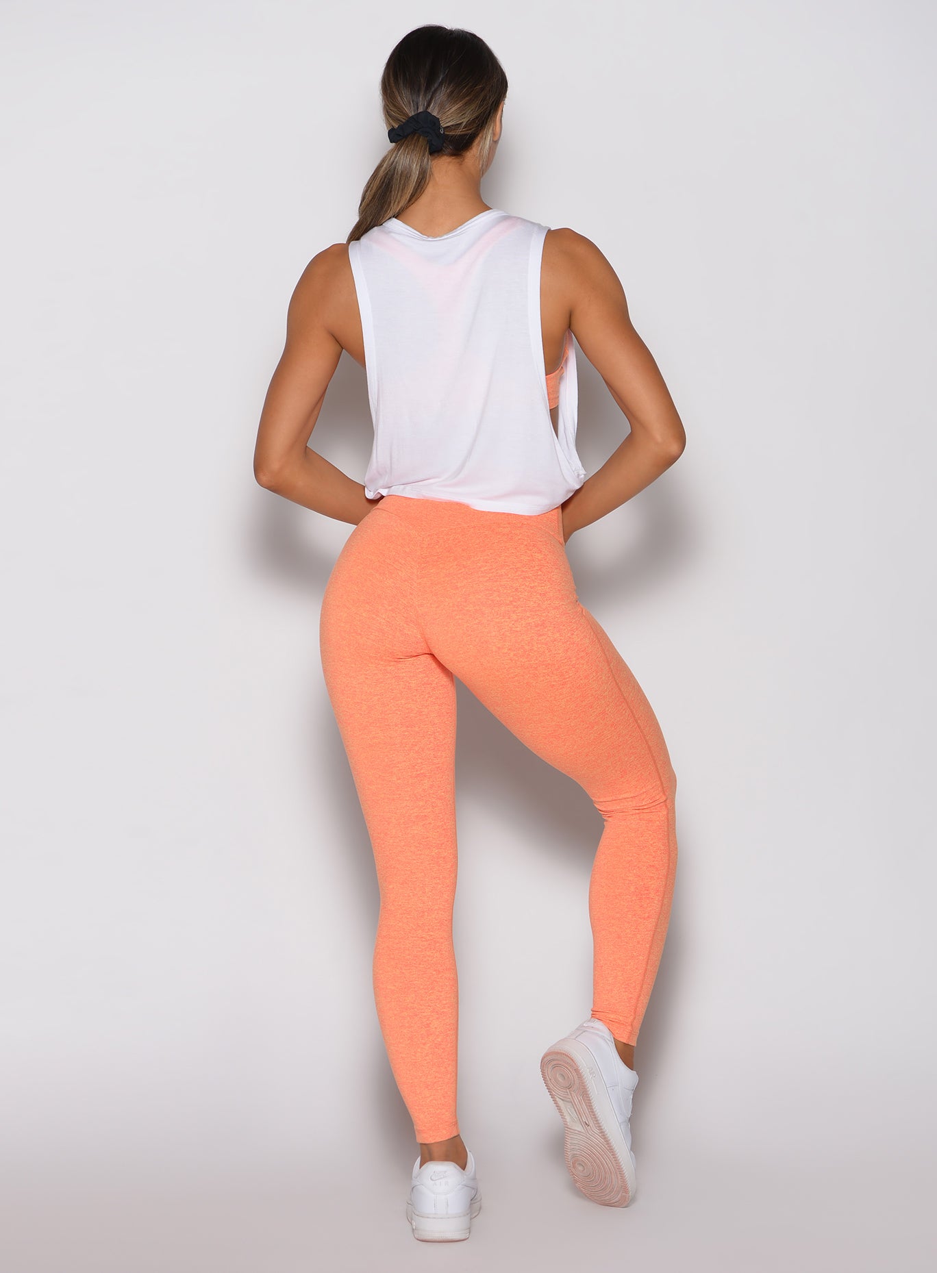 Back side profile of Citrus Glow Lift Movement Leggings and white ombre logo tank gym set.