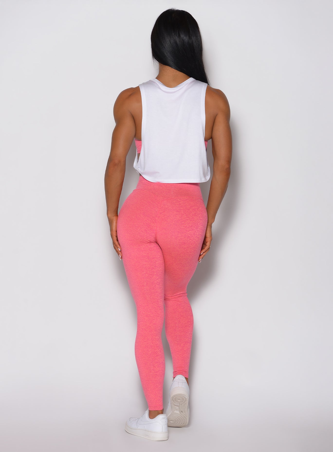 Back view of Neon Tangerine Punch Lift Movement Leggings with an internal glute-lifting scrunch.