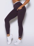 close up left side view of a model wearing the Line Contour Leggings in black orchid color 