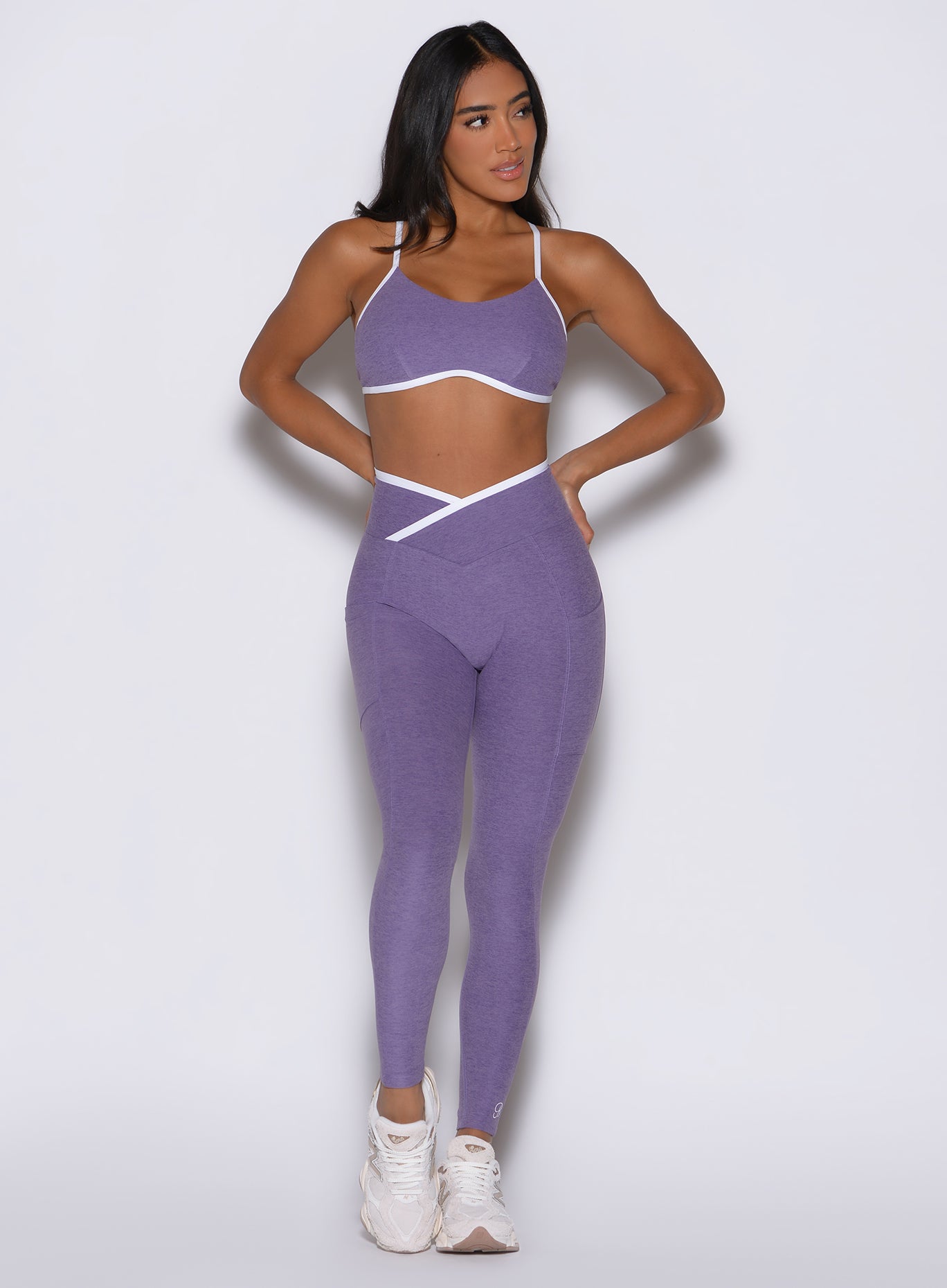 Front view of Violet Line Contour Leggings with white contrast piping and a mid-rise fit.