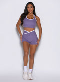 frontal shot of a model with both hands on her thighs wearing the Line Contour Shorts in Violet color