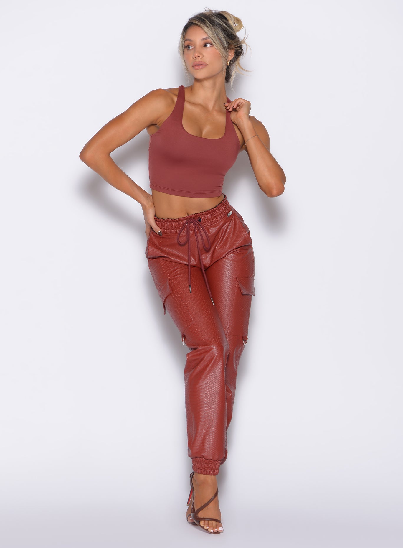 High-waisted Brick Red Liquid Cargos in sleek PU leather; a sculpting day-to-night statement piece.