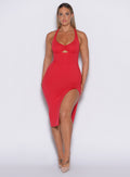 front profile picture of a model facing forward wearing our bright red dress with a high side slit on the left 