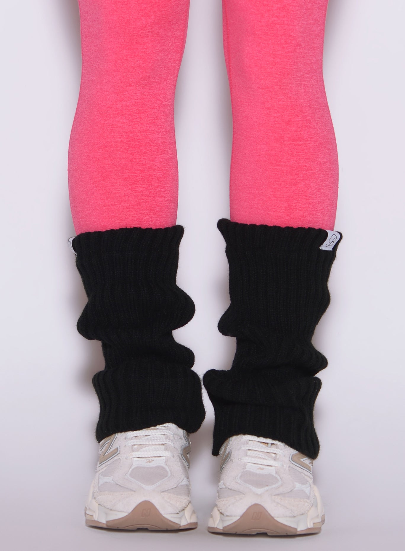 close up front view of a model wearing the Luxe Leg warmers-short in black color