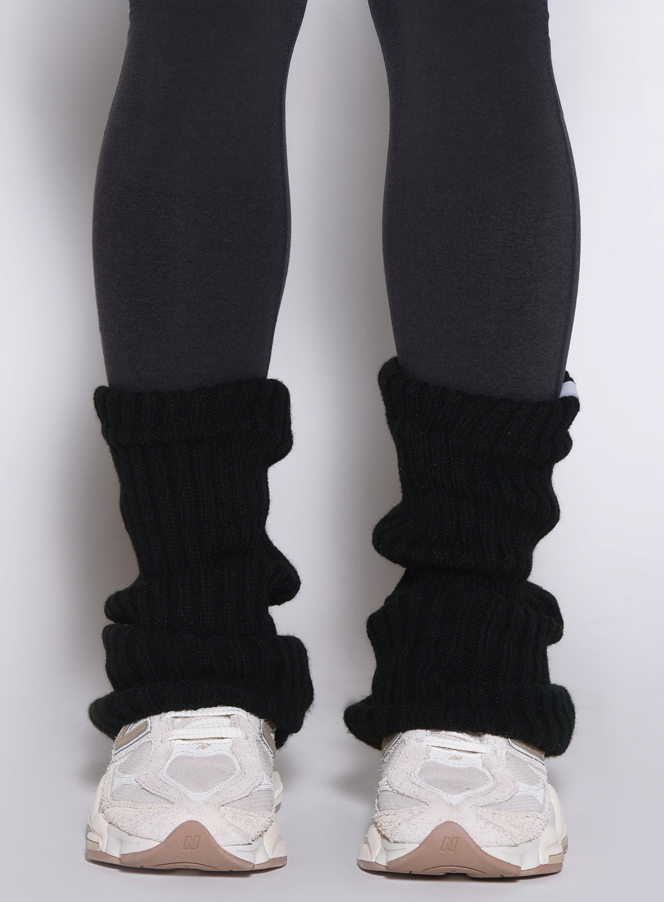 close up front view of a model wearing the Luxe Leg warmers-short in black color