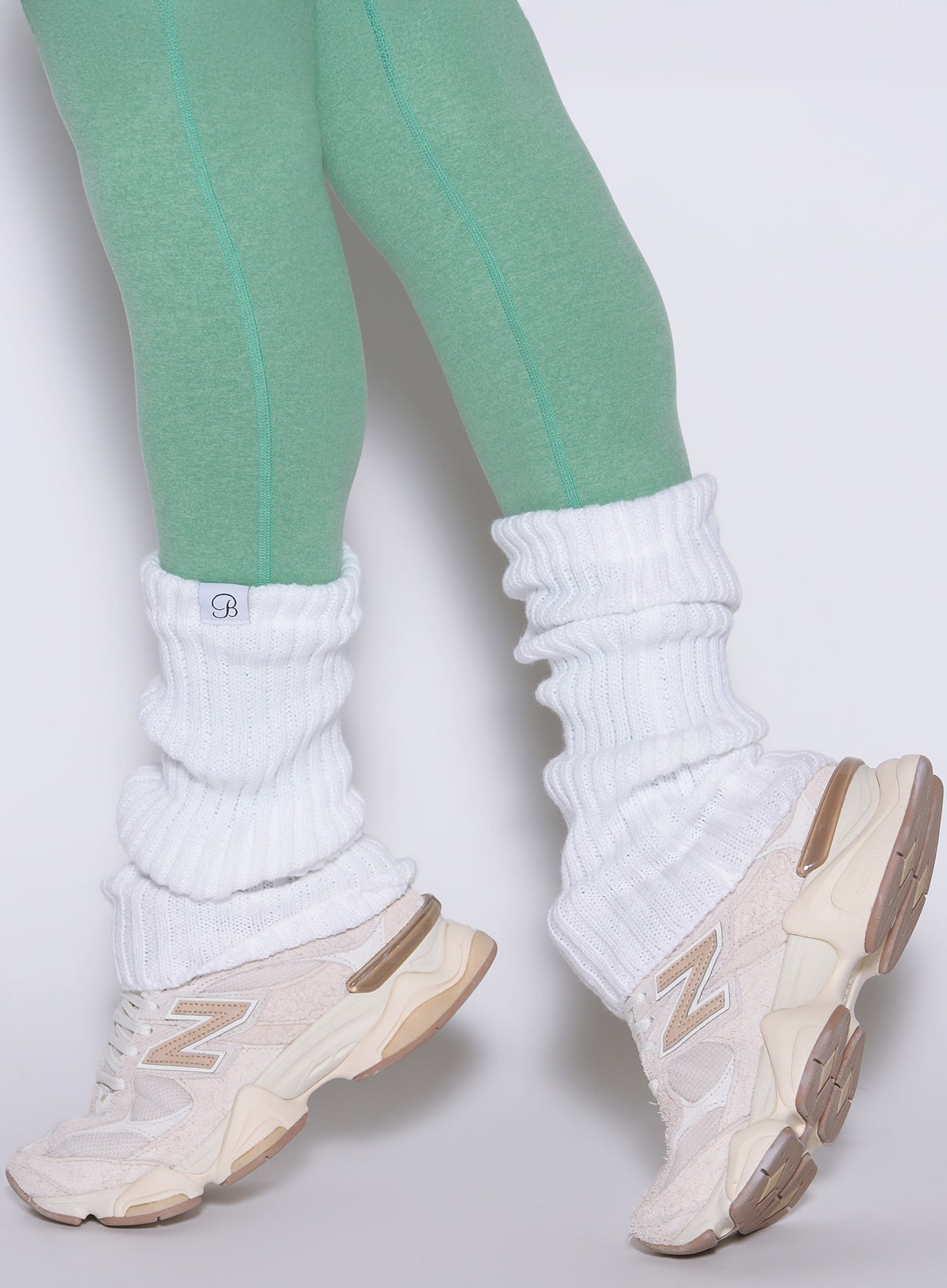 White Luxe Leg Warmers in a short, chunky rib knit style for a retro-athletic gym look.