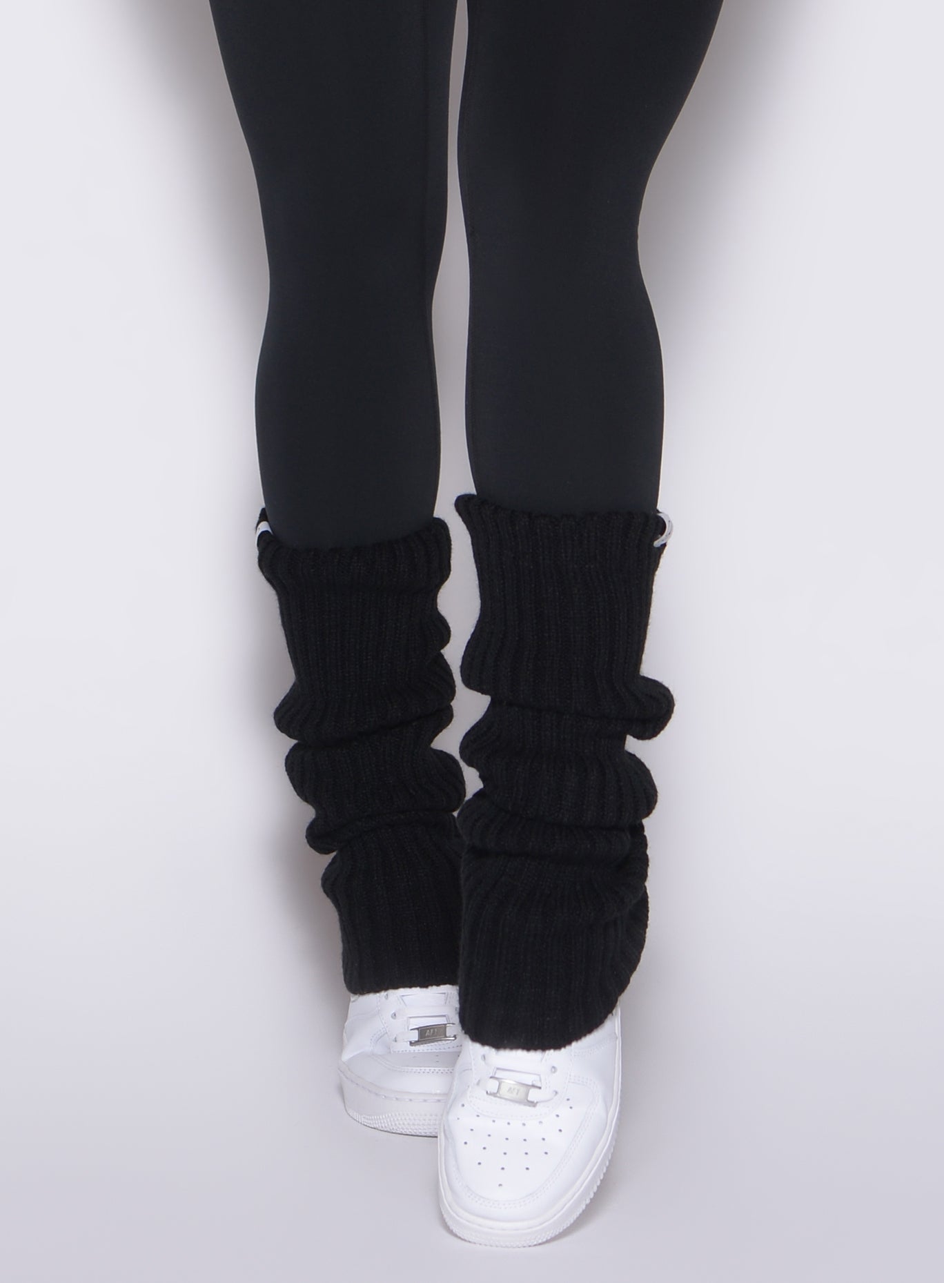 Ribbed black Luxe Leg Warmers with a plush knit and stay-put elastic for stylish gym layering.