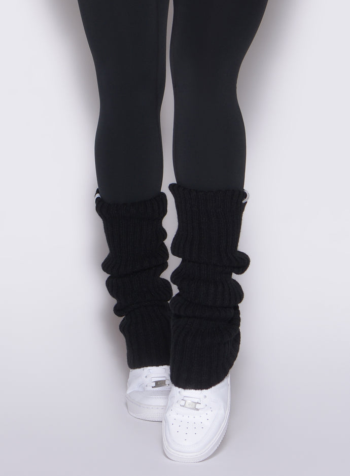 close up front profile view of a model wearing the Luxe Leg Warmers in black color