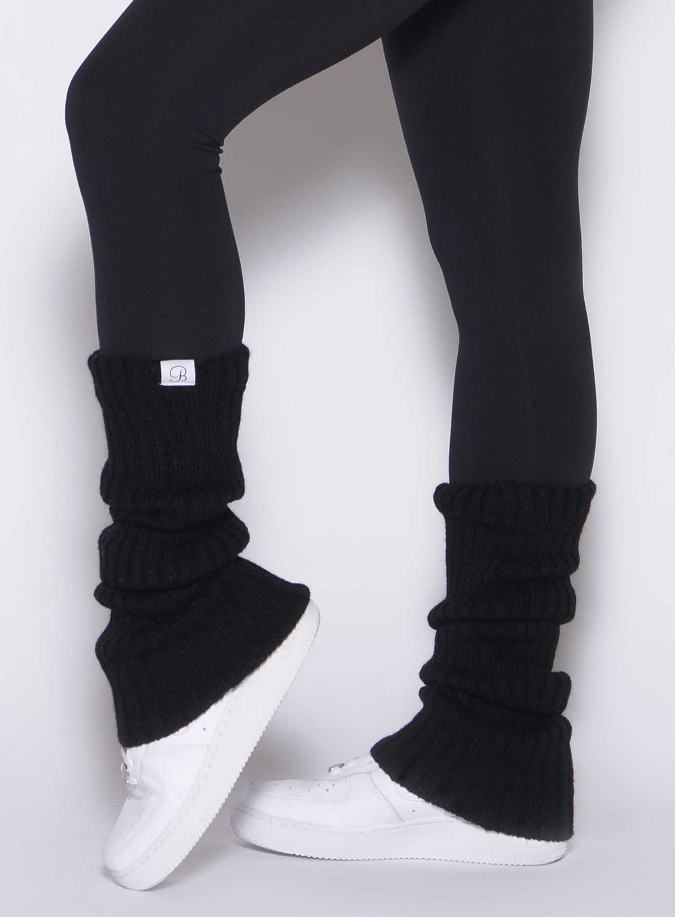 Black Luxe Leg Warmers in a plush ribbed knit; cozy layering for gym warmth and style.