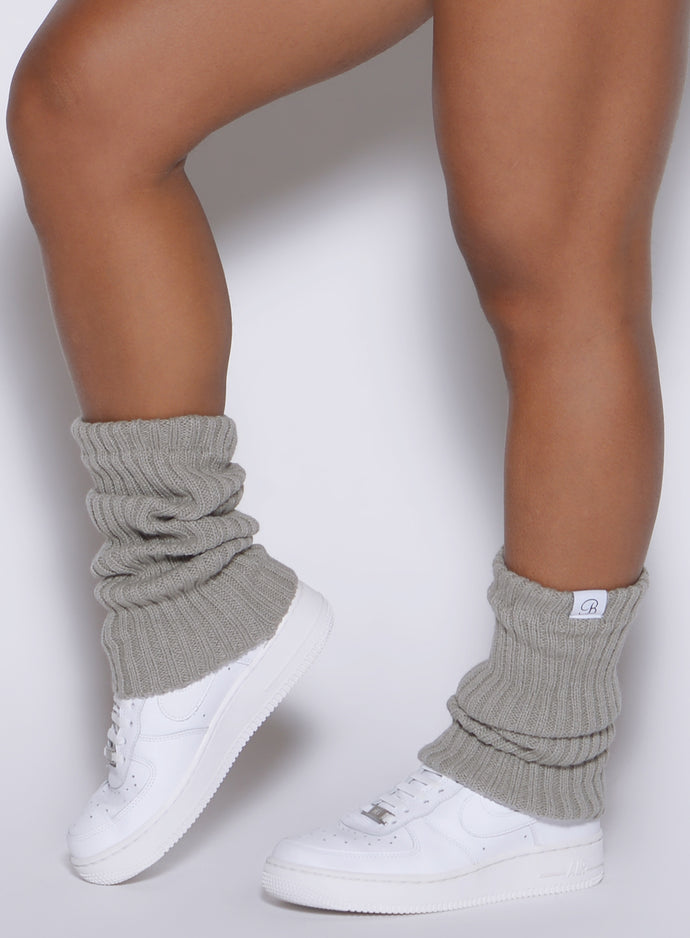 left side shot of a model wearing the luxe leg warmers-short in dark and stormy color