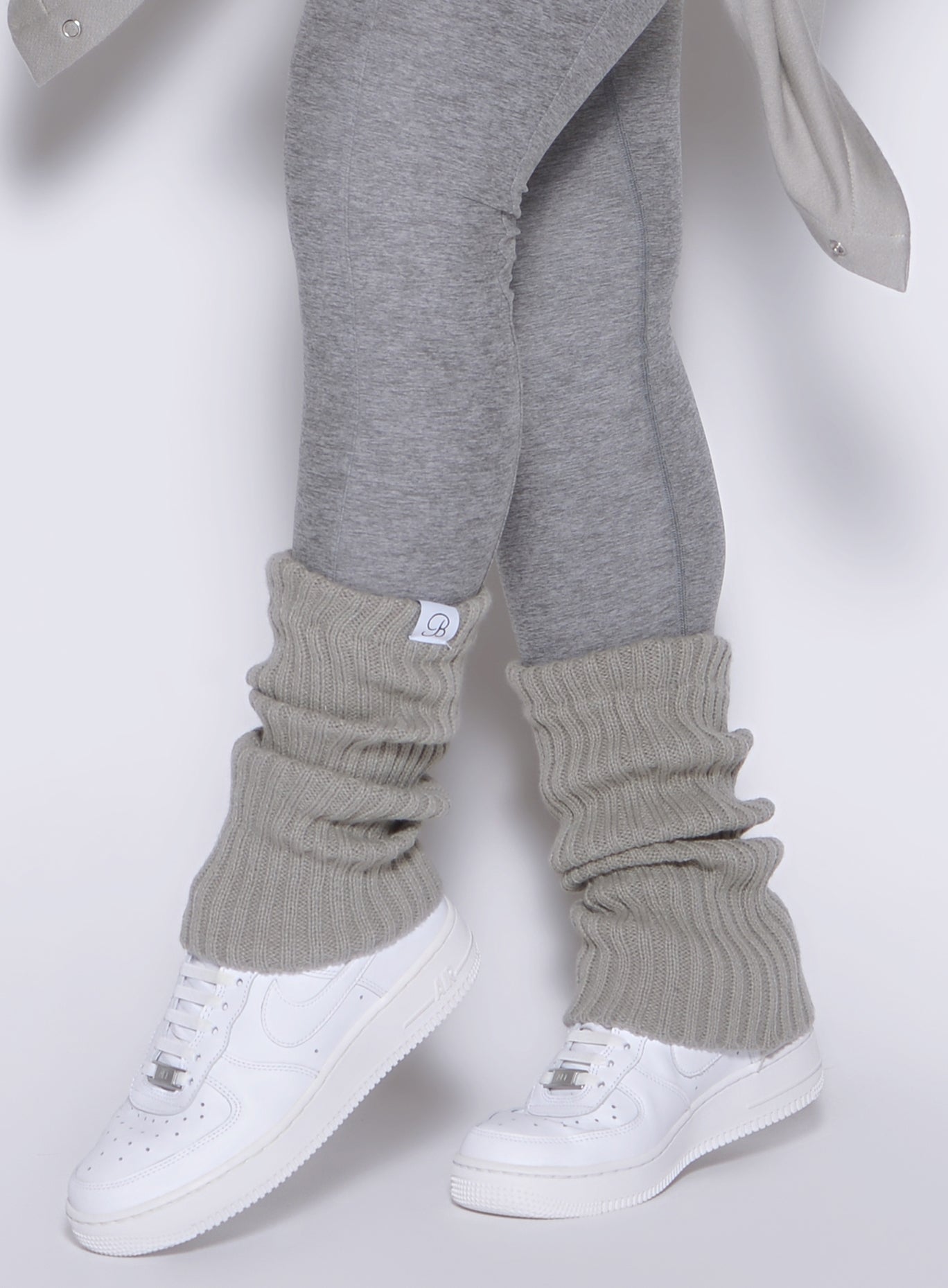 left side view of a model wearing the luxe leg warmers-short in dark and stormy color