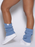left side view of a model wearing the luxe leg warmers-short in niagara mist color