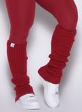 close up front right side view of a model wearing the Luxe Leg Warmers in red velvet color