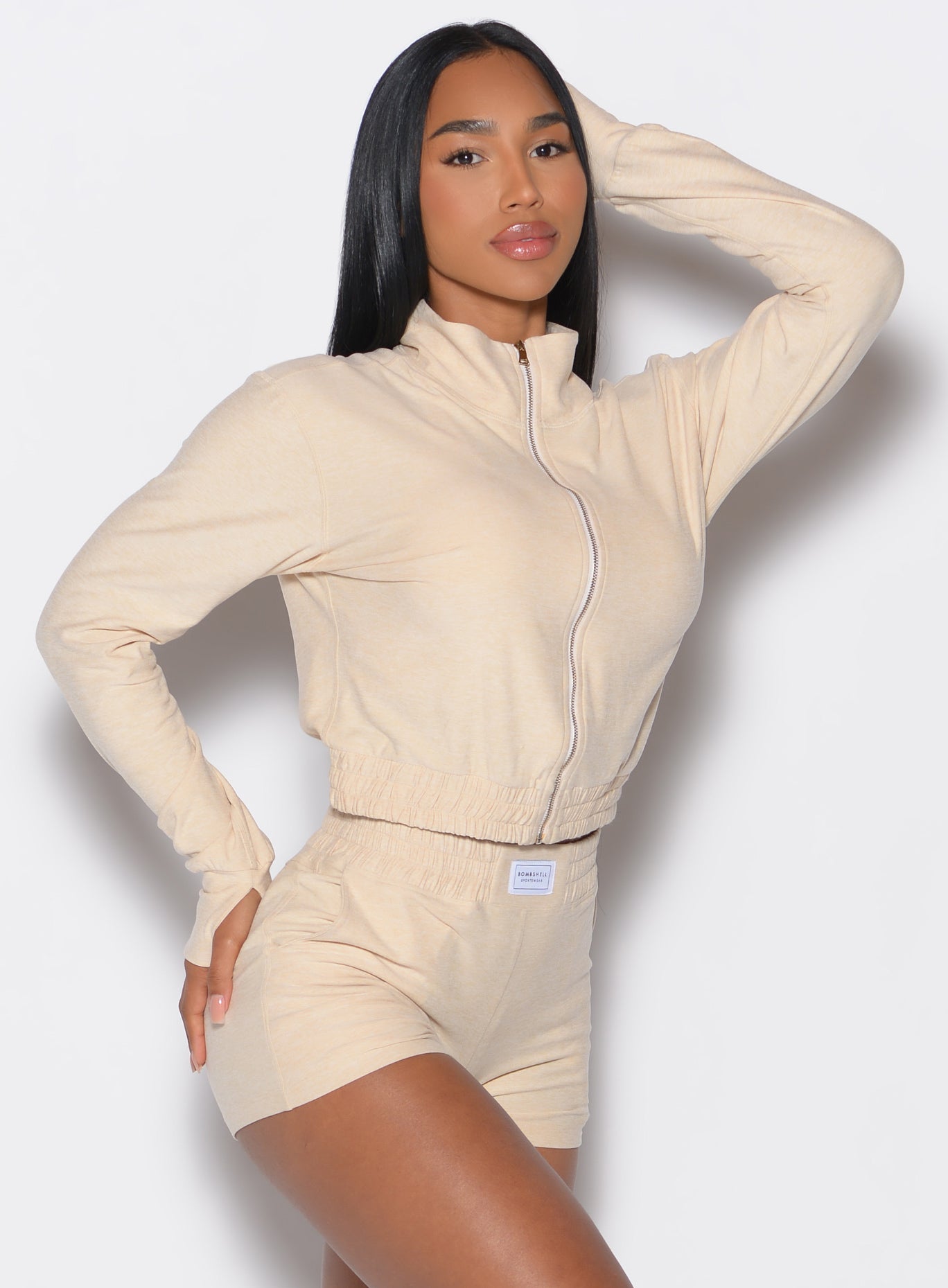Sleek Vanilla Cloud Full Length Jacket with a mock neck and thumbholes for stylish gym layering.