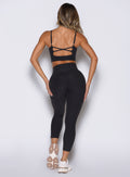 back profile view of a model wearing the Movement 7/8 Leggings in heathered black color