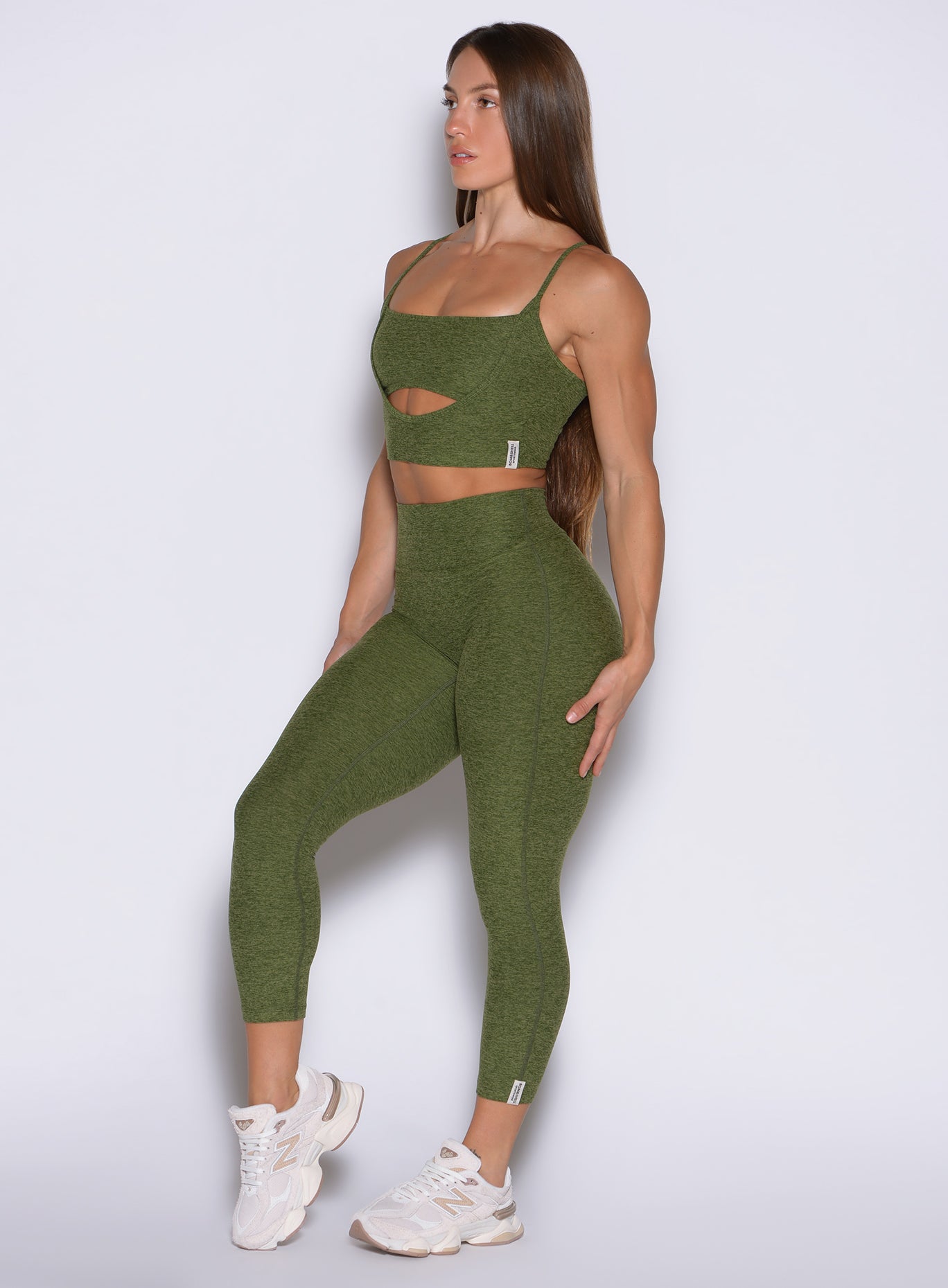 front left side profile view of a model wearing the Movement 7/8 Leggings in Juniper color