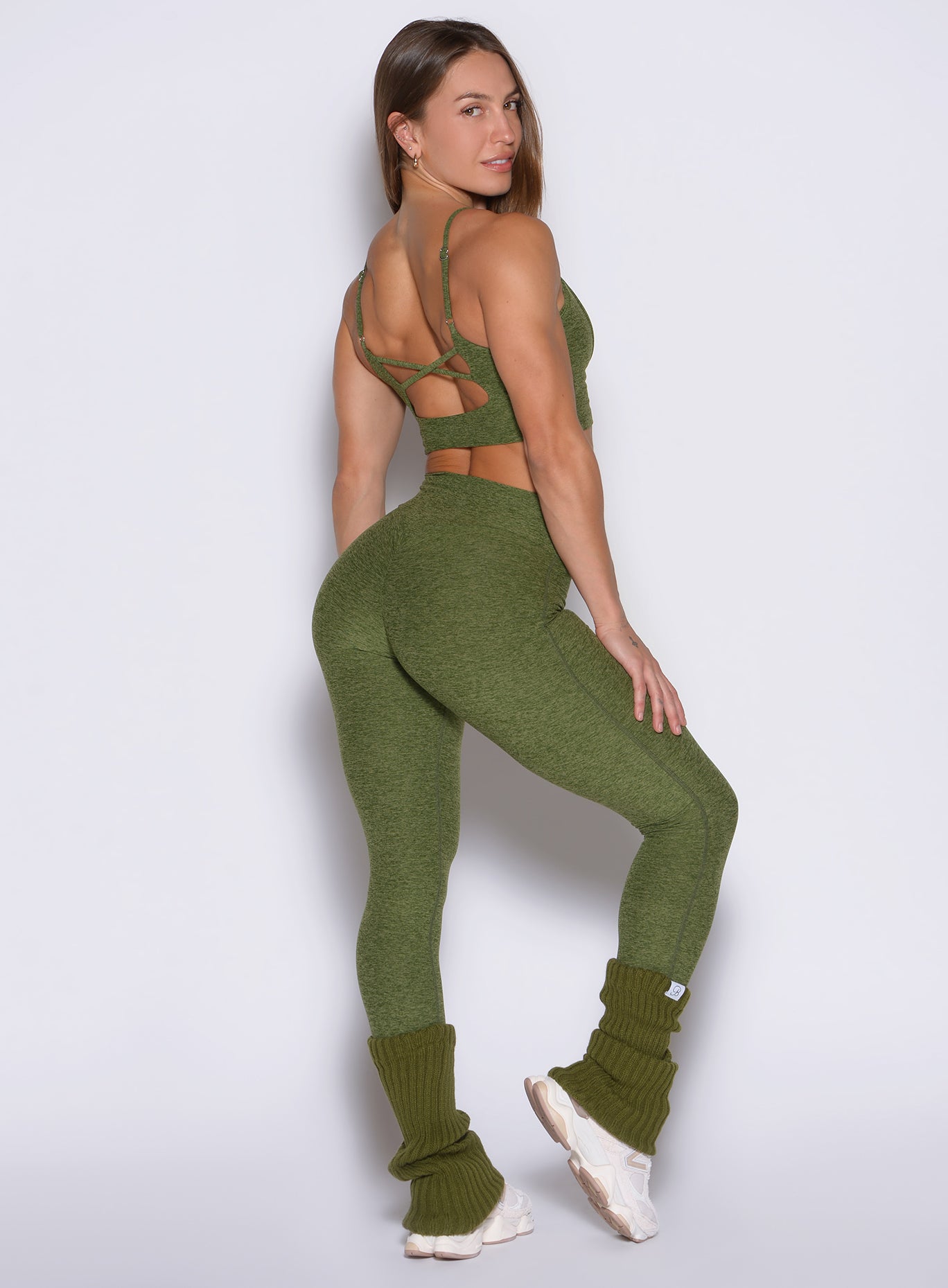 back right side profile view of a model wearing the Movement 7/8 Leggings in Juniper color