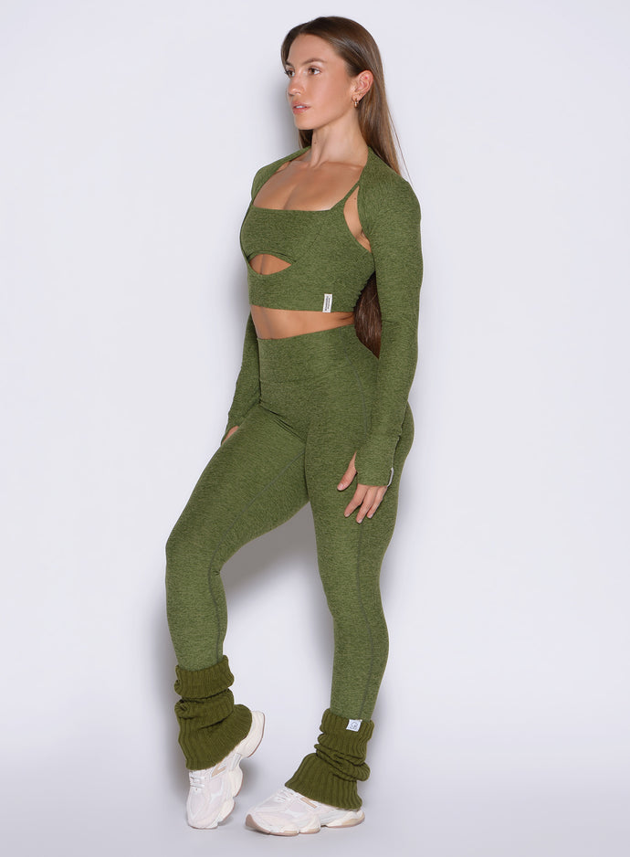 front left side view of a model wearing the Movement 7/8 Leggings in Juniper color paired with the matching tops