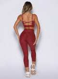 back side view of a model wearing the Movement 7/8 Leggings in rouge color