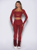 front view of a model wearing the Movement 7/8 Leggings in rouge color paired with the matching tops