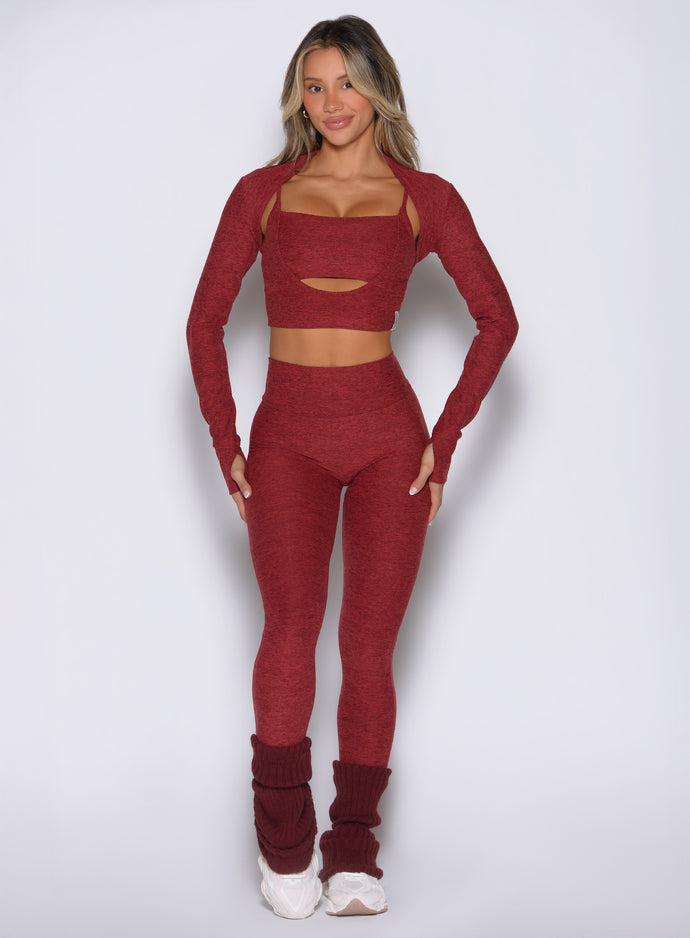 front view of a model wearing the Movement 7/8 Leggings in rouge color paired with the matching tops