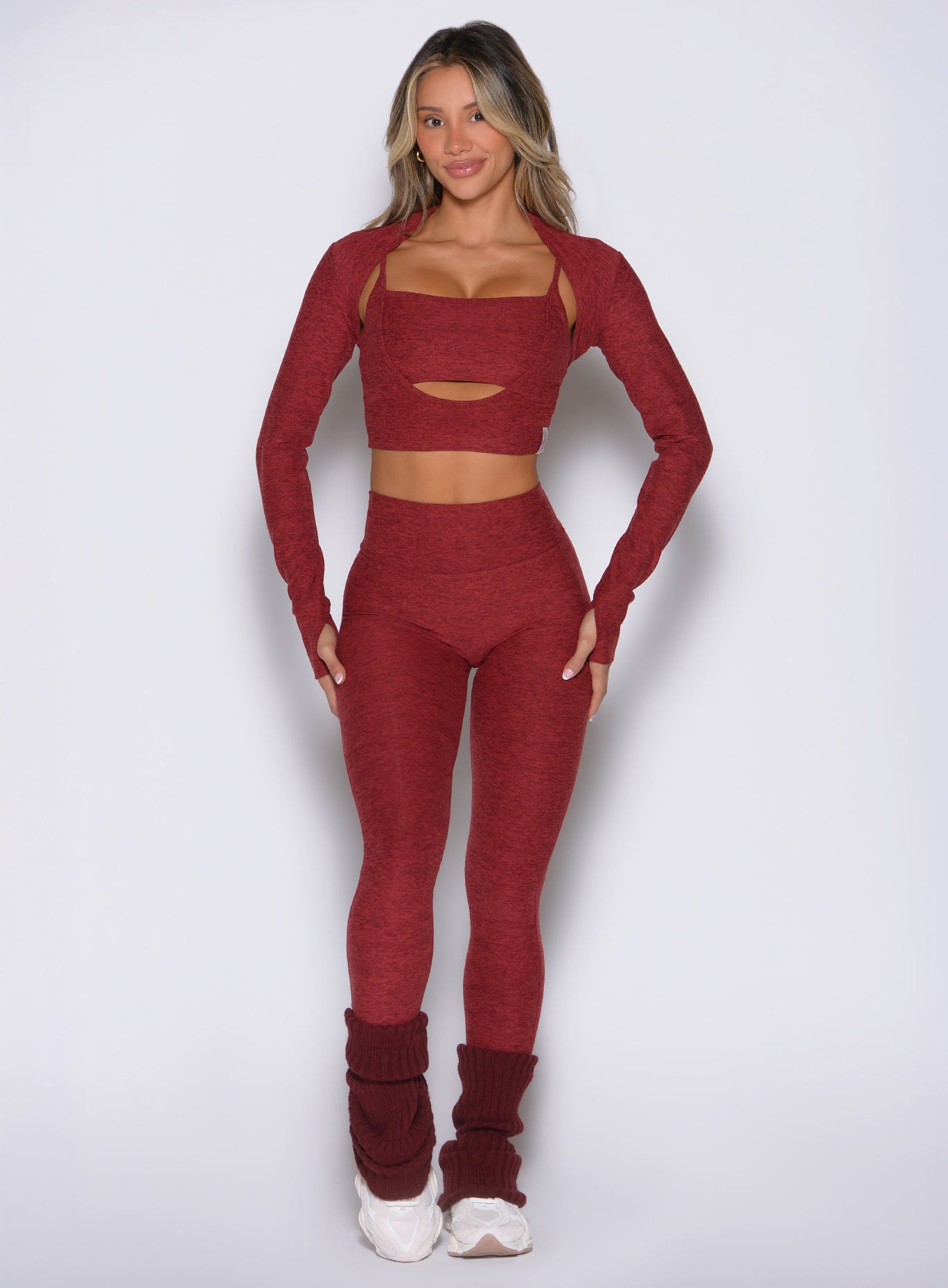 front view of a model wearing the Movement 7/8 Leggings in rouge color paired with the matching tops