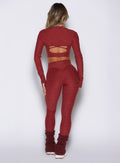 back side view of a model wearing the Movement 7/8 Leggings in rouge color paired with the matching tops 