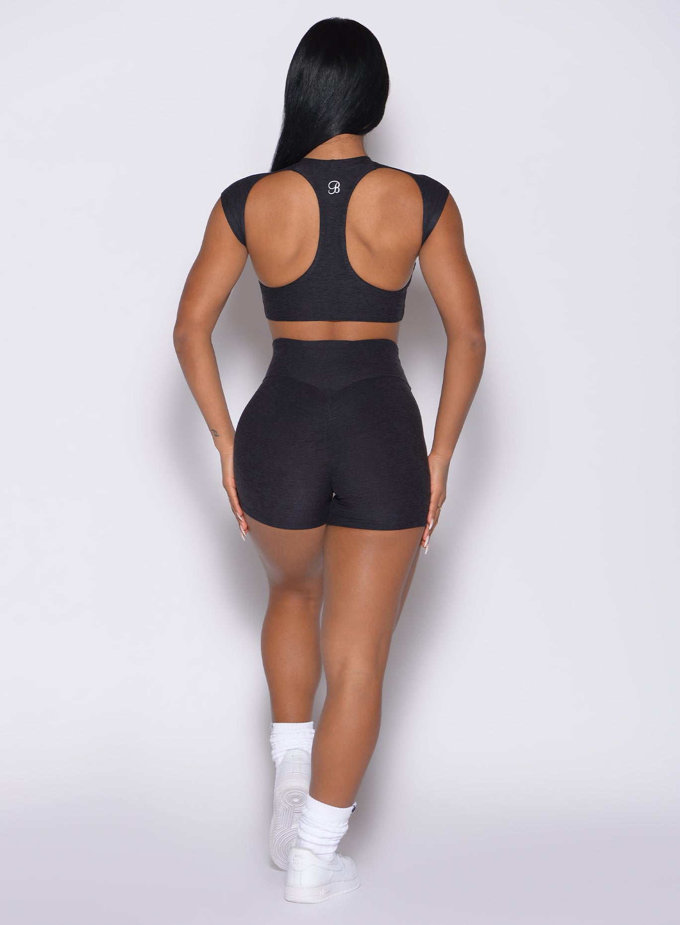 Sculpting Heathered Black Movement Shorts with a sweetheart booty seam for a lifted gym look.