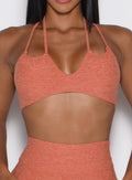 front view of a model wearing the MulTie Sports Bra in spiced maple color