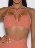 close up front view of a model wearing the MulTie Sports Bra in spiced maple color