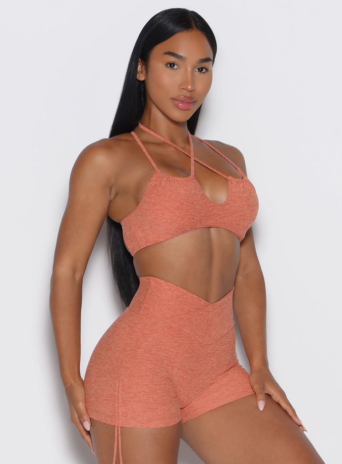 front side view of a model wearing the MulTie Sports Bra in spiced maple color