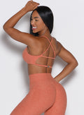 back left side profile view of a model wearing the MulTie Sports Bra in spiced maple color