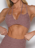 close up front view of a model wearing the MulTie Sports Bra in walnut color 