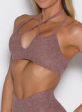 close up front left side profile view of a model wearing the MulTie Sports Bra in walnut color 