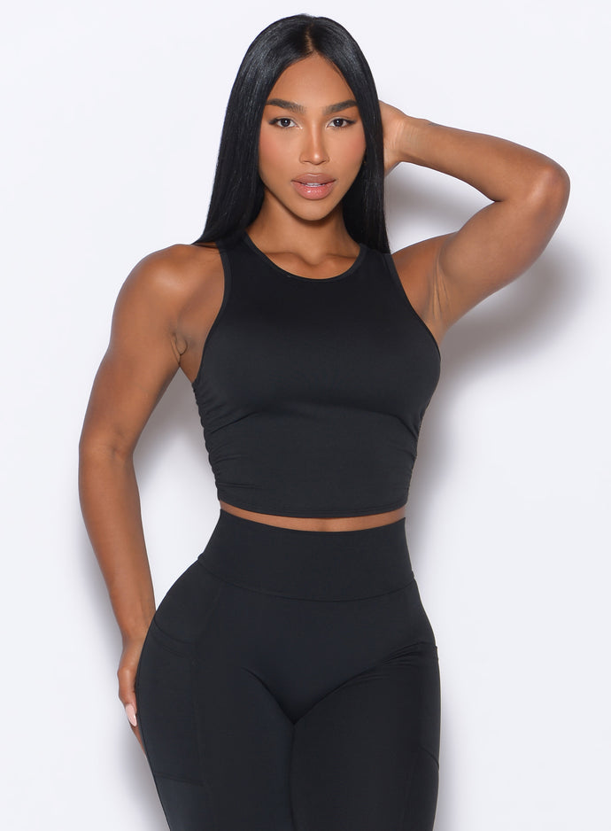 front profile view of a model wearing our Muscle Scrunch Tank in Black color
