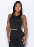 front profile view of a model posing in our Muscle Scrunch Tank in Black color
