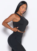 right side profile view of a model wearing our Muscle Scrunch Tank in Black color

