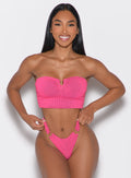 front profile view of a model with both hands on her waist wearing the Neon Nights Bikini Bandeau in Pink Passion color