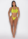 front profile view of a model looking to the left side wearing the Neon Nights Bikini Bottoms in Lemon Drop color 