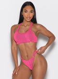 front profile view of a model wearing the Neon Nights Bikini Top in Pink Passion color