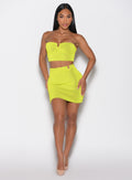 front profile view of a model with both hands on her thighs wearing the Neon Nights Skirt in Lemon Drop color