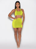 front profile view of a model with one hand on her waist wearing the Neon Nights Skirt in Lemon Drop color paired with the matching bra