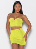 front profile view of a model wearing the Neon Nights Bikini Bandeau in Lemon Drop color paired with the matching skirt