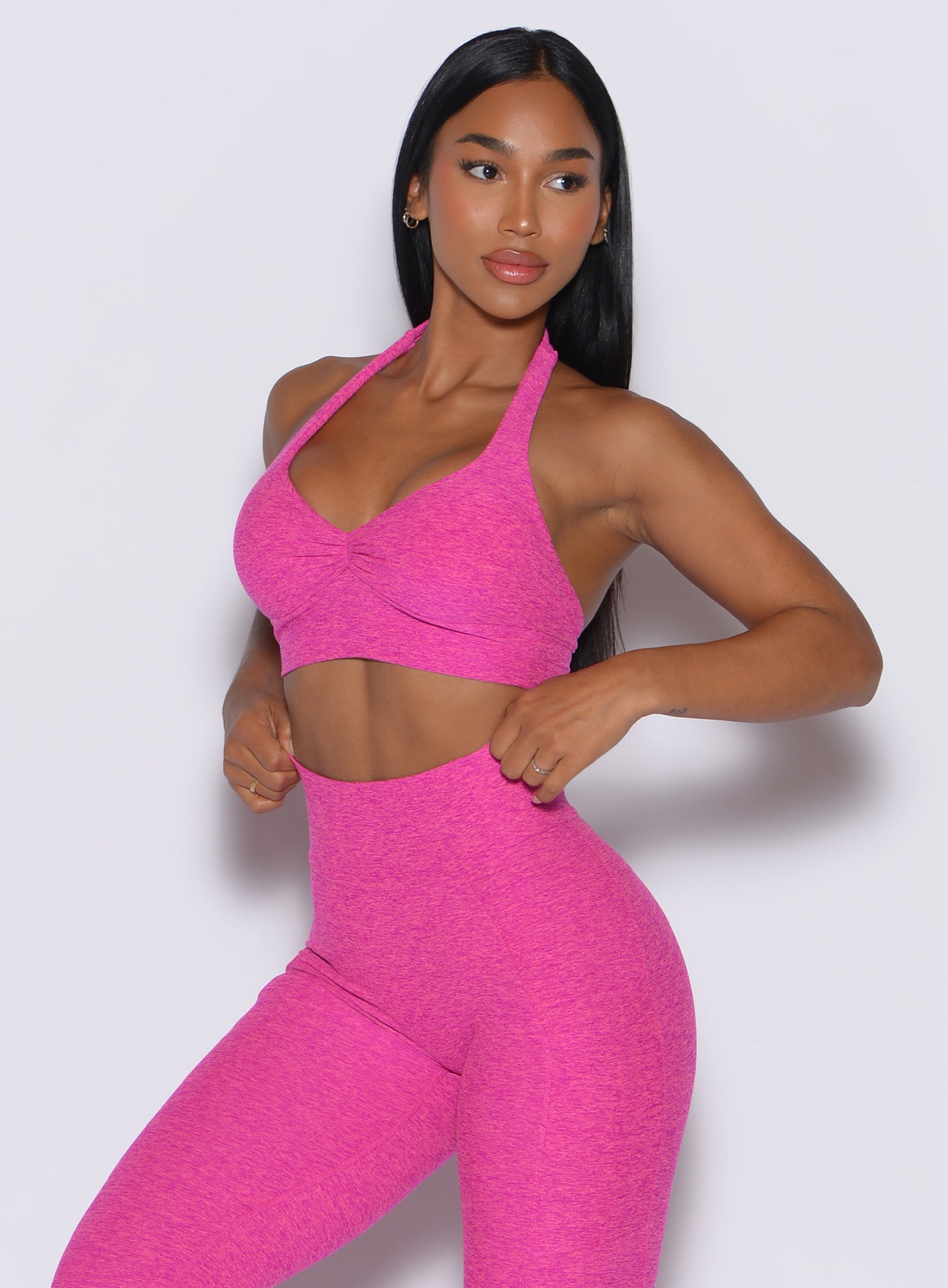 front profile picture of a model wearing our backless bra in Neon Pink Sorbet color along with the matching leggings